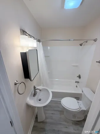 a bathroom with a sink a mirror and a shower