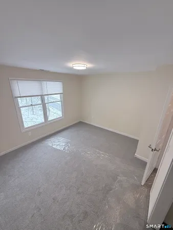an empty room with closet and mirror