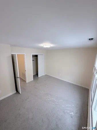 an entryway door with white walls