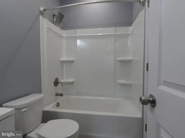 a bathroom with a toilet and a bathtub