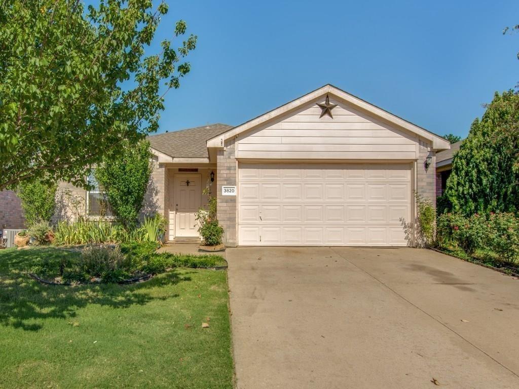 a view of a house with a yard and garage