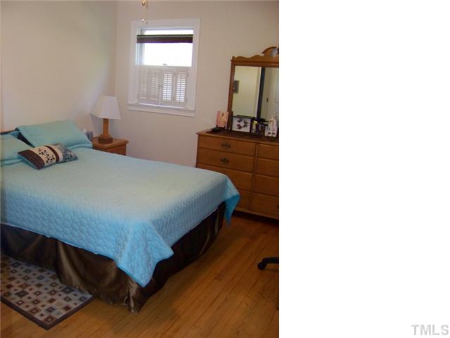 4409 Greenbrier Road Raleigh, NC 27603 - Photo 6 of 12 a bedroom with a bed and a window