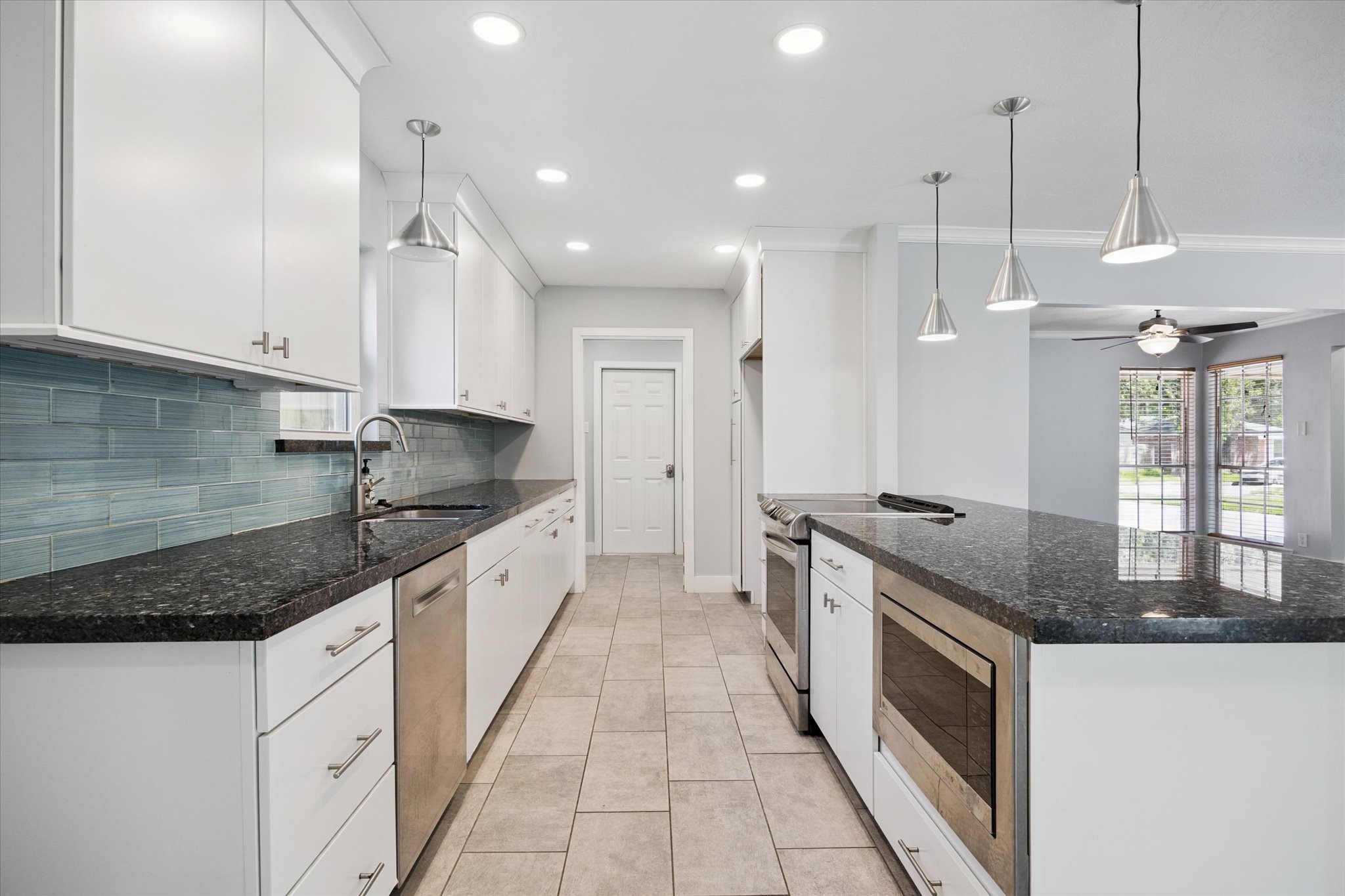 9407 Meadowbriar Lane Houston, TX 77063 - Photo 12 of 25 Dreamy white cabinets with contrasting galaxy granite counter tops.