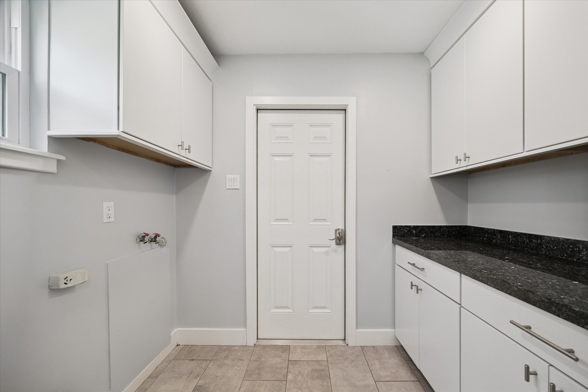 9407 Meadowbriar Lane Houston, TX 77063 - Photo 23 of 25 Convenient laundry / mud room with built in cabinets and folding space.