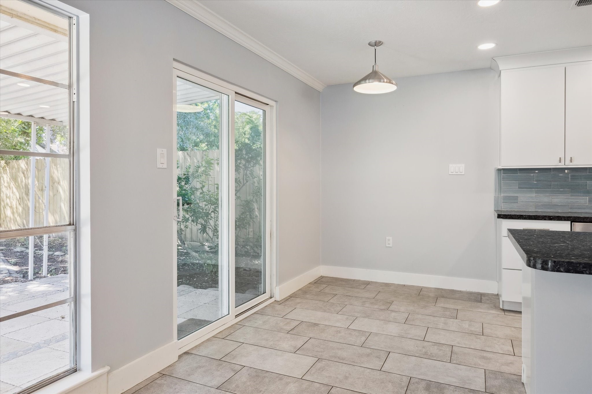 9407 Meadowbriar Lane Houston, TX 77063 - Photo 10 of 25 Breakfast space leads conveniently to covered back patio, perfect for taking coffee in the morning.