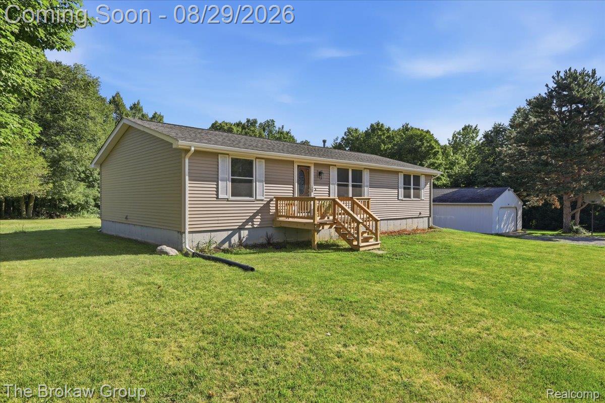 5411 Hess Road Dryden, MI 48428 - Photo 3 of 56 Single-story residence featuring siding exterior, an elevated wood deck entry, and a detached outbuilding