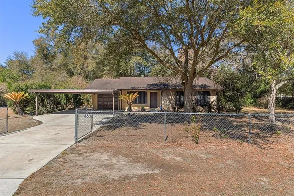 a view of a house with a backyard