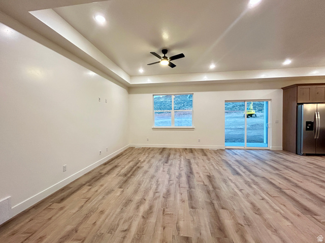 6 South 450th West Gunnison, UT 84634 - Photo 11 of 45 Open-concept living space featuring wood-finish flooring, a tray ceiling with recessed lighting, and a ceiling fan