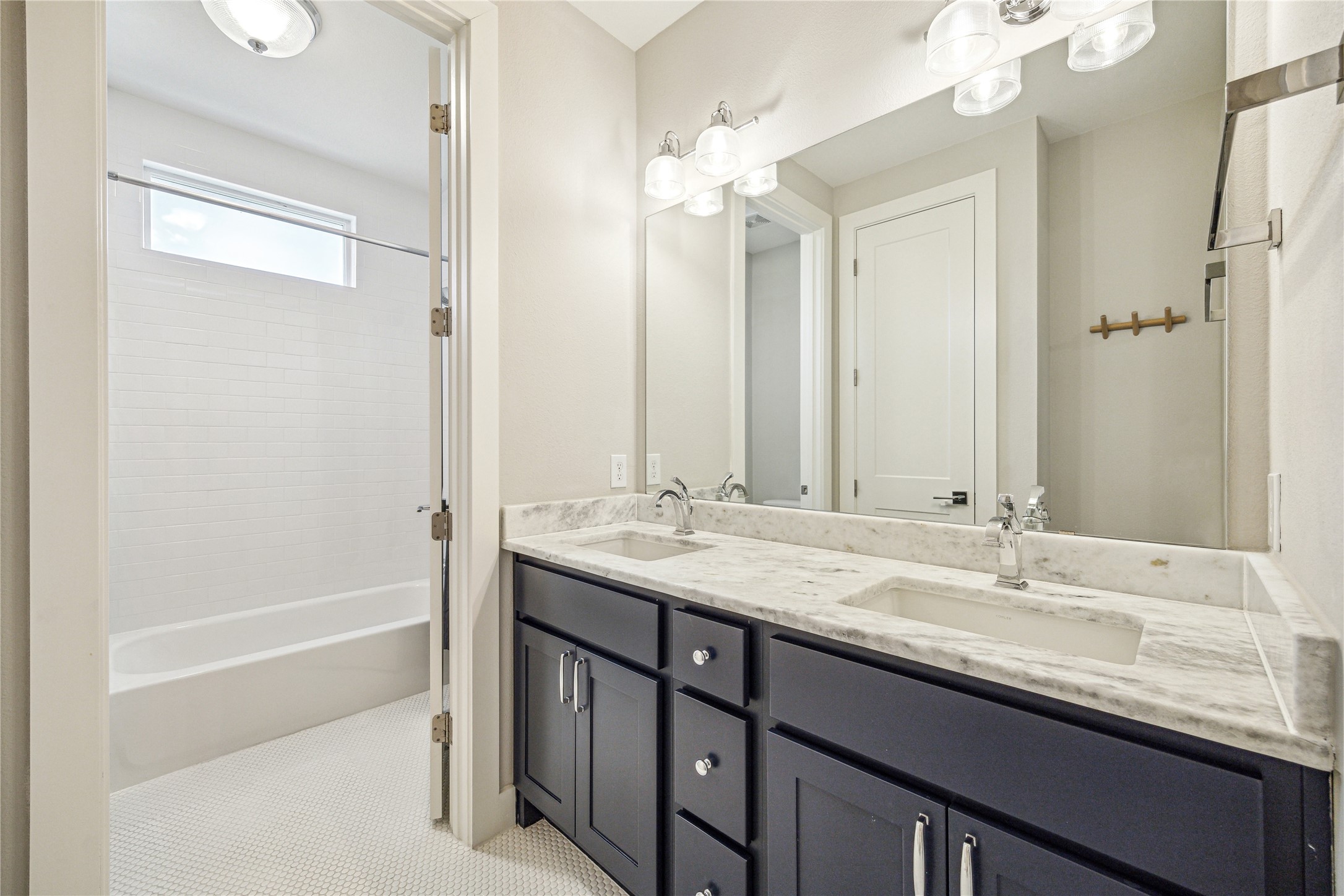 603 Vincent Street Houston, TX 77009 - Photo 18 of 26 The charming secondary bathroom features double sinks + private water closet area.