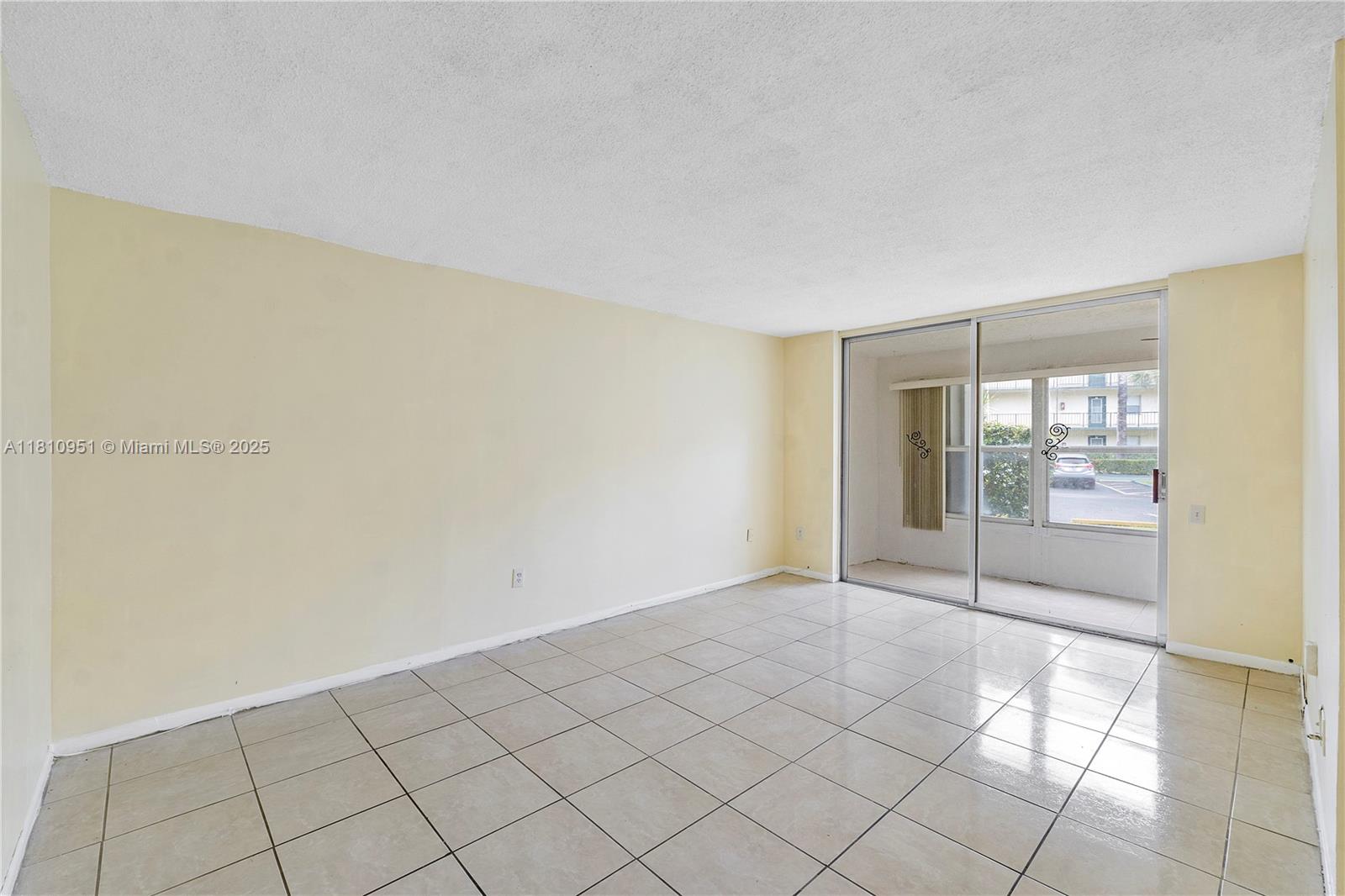 9091 Lime Bay Boulevard, Unit 110 Tamarac, FL 33321 - Photo 14 of 40 a view of an empty room and window