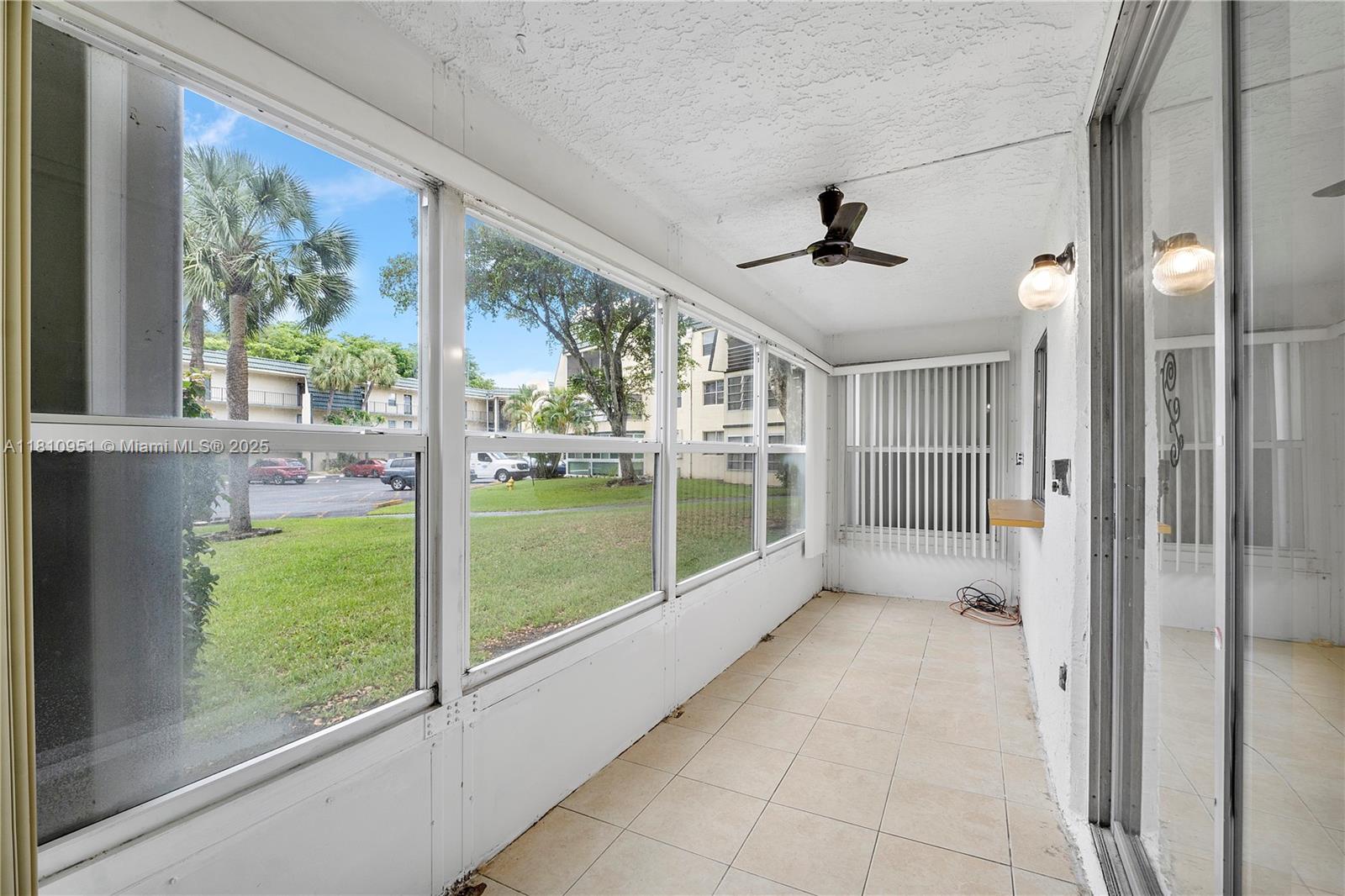 9091 Lime Bay Boulevard, Unit 110 Tamarac, FL 33321 - Photo 18 of 40 a view of a room that has a large window and front door