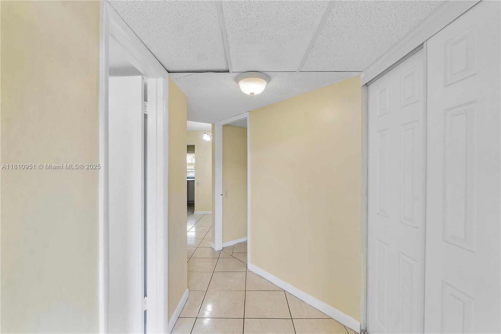 9091 Lime Bay Boulevard, Unit 110 Tamarac, FL 33321 - Photo 20 of 40 a view of a hallway with wooden shelves