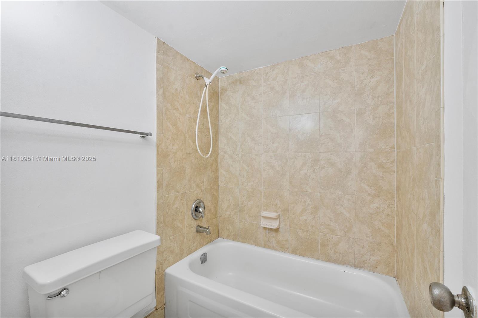 9091 Lime Bay Boulevard, Unit 110 Tamarac, FL 33321 - Photo 26 of 40 a bathroom with a toilet and shower