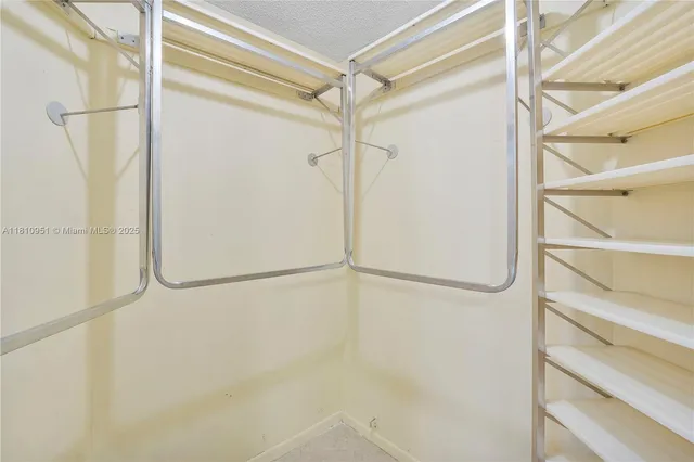 a view of a house with a yard and palm trees