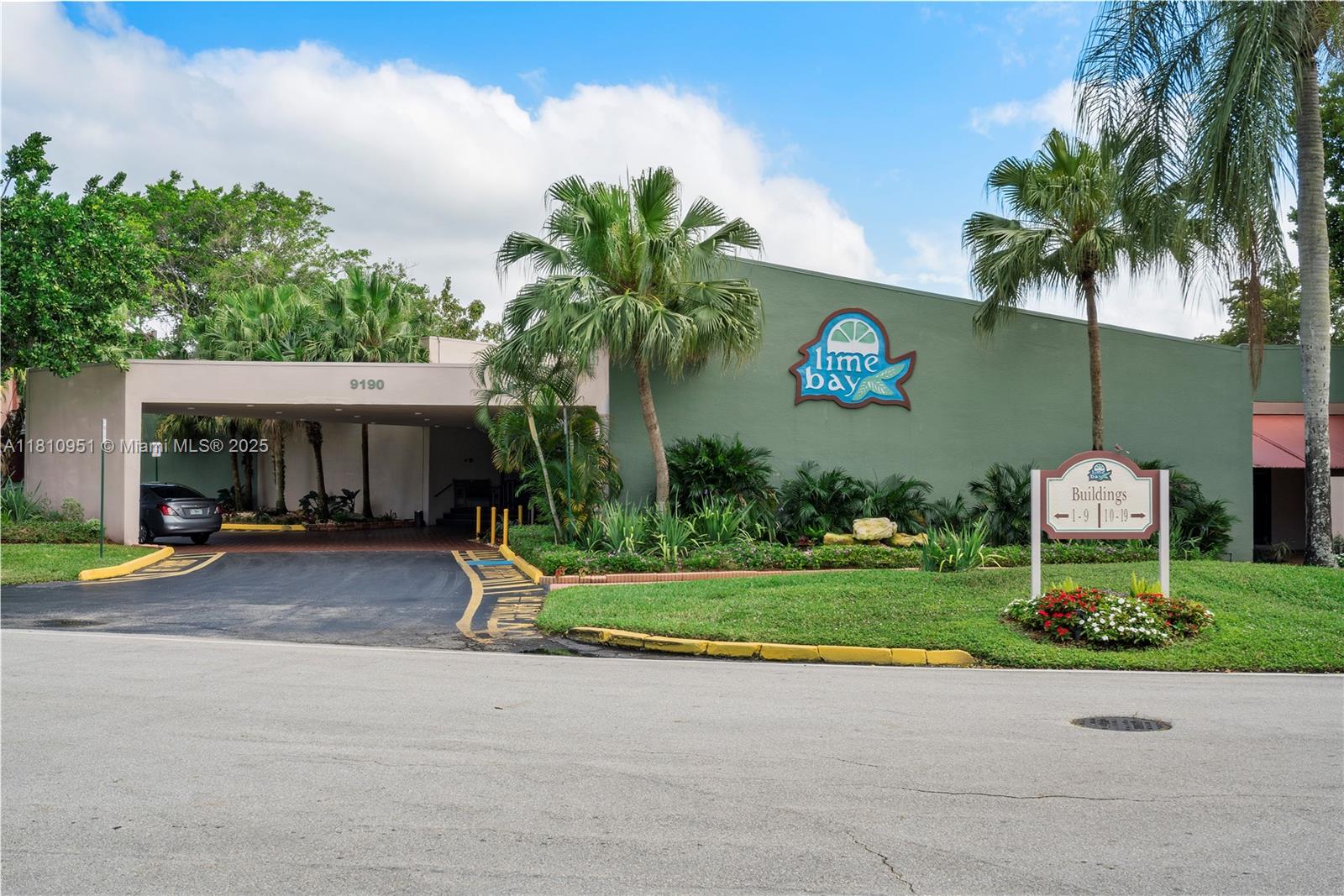 9091 Lime Bay Boulevard, Unit 110 Tamarac, FL 33321 - Photo 28 of 40 a view of a house with a yard and palm trees