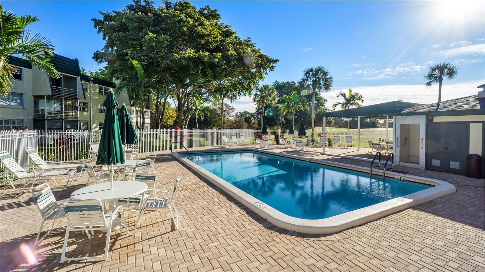 9091 Lime Bay Boulevard, Unit 110 Tamarac, FL 33321 - Photo 31 of 40 a view of a swimming pool with a patio