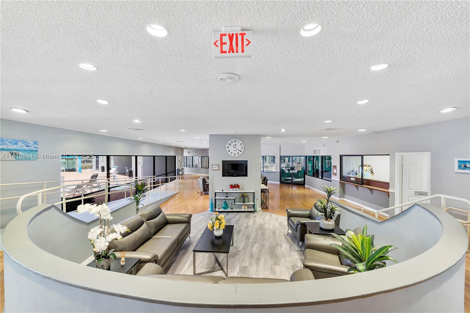 9091 Lime Bay Boulevard, Unit 110 Tamarac, FL 33321 - Photo 34 of 40 a living room with furniture and a wooden floor