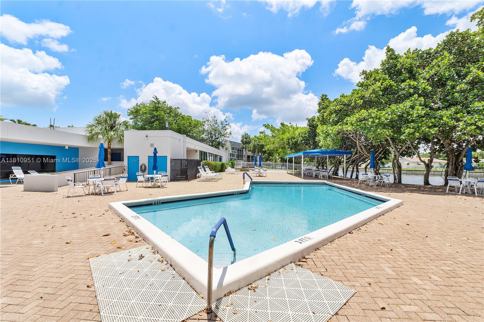 9091 Lime Bay Boulevard, Unit 110 Tamarac, FL 33321 - Photo 37 of 40 a view of a swimming pool with a patio