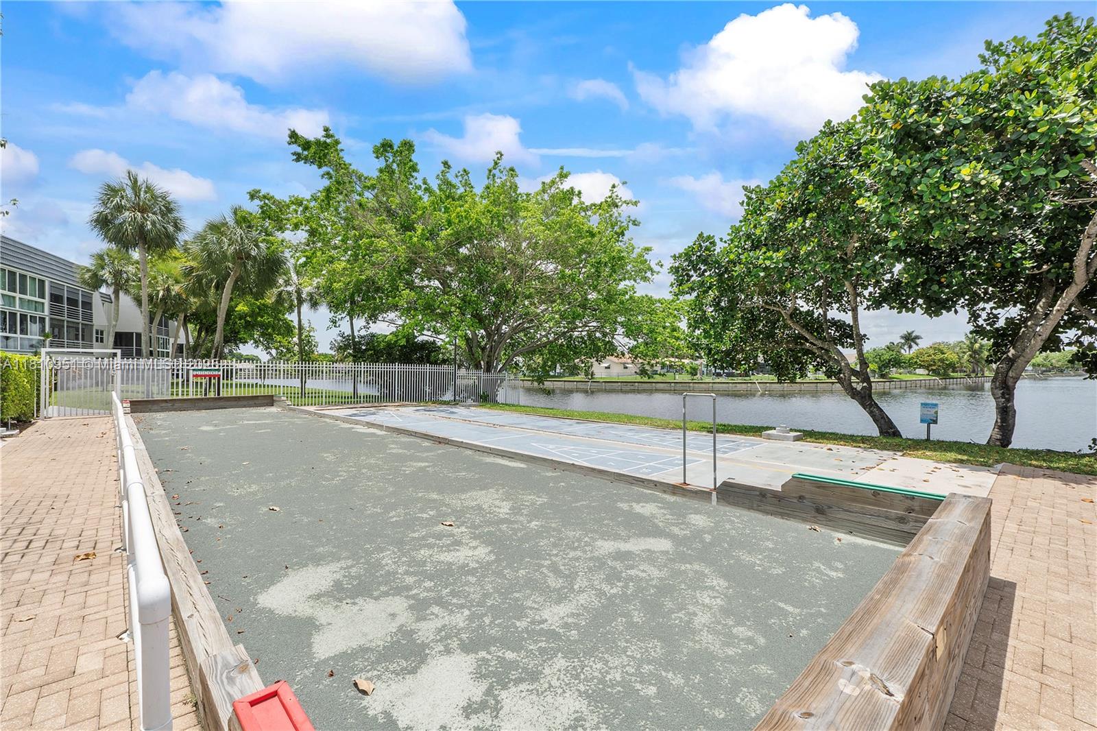 9091 Lime Bay Boulevard, Unit 110 Tamarac, FL 33321 - Photo 39 of 40 a view of a tennis court
