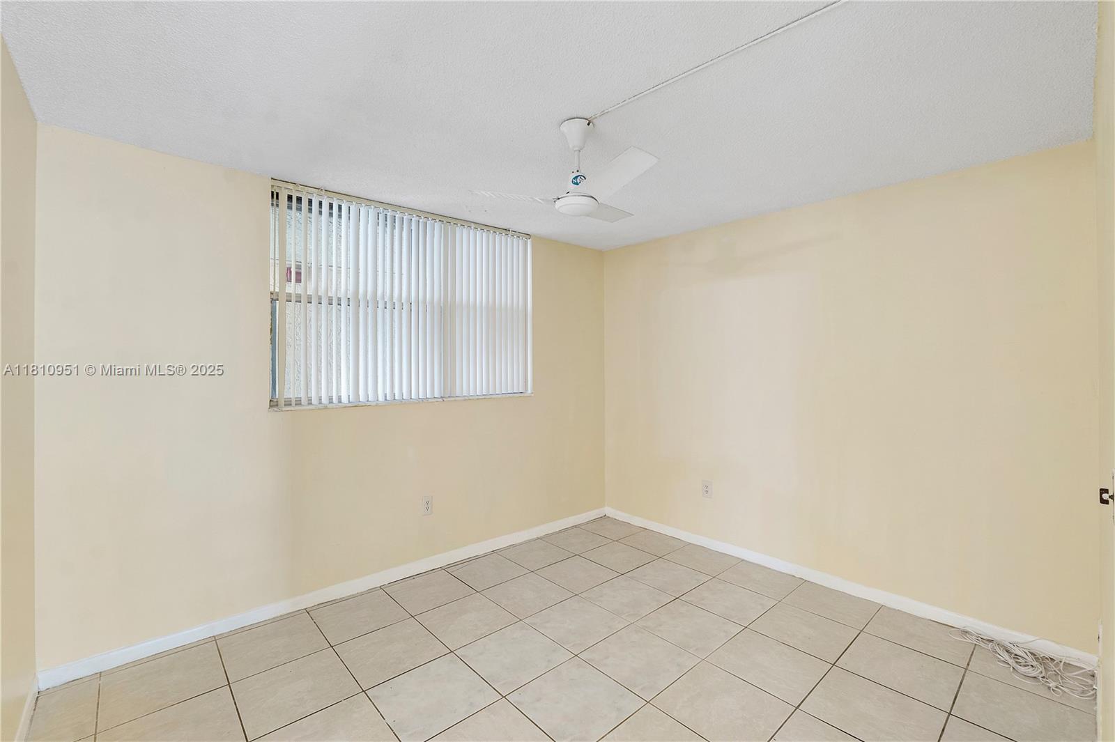 9091 Lime Bay Boulevard, Unit 110 Tamarac, FL 33321 - Photo 7 of 40 an empty room with windows