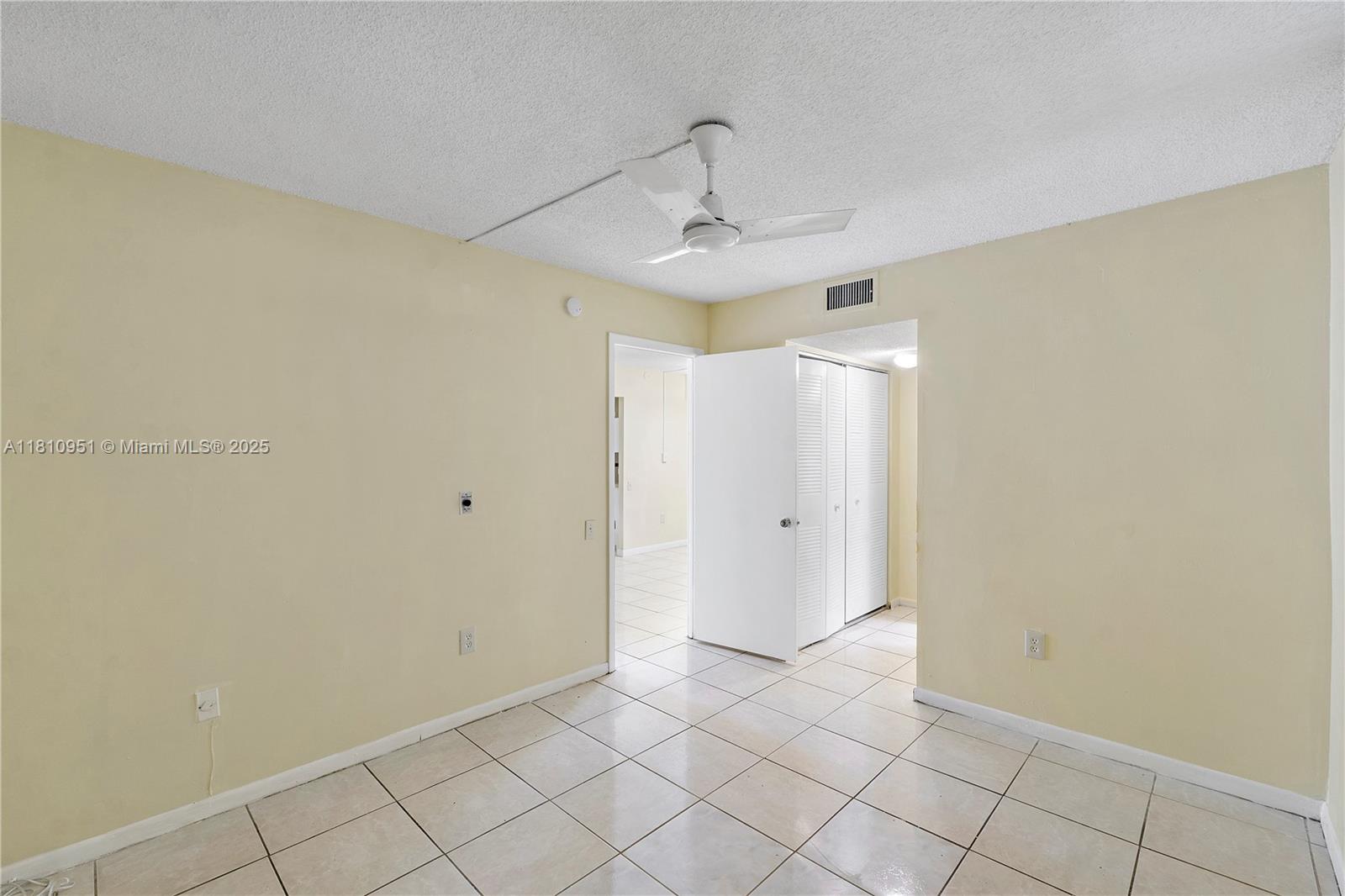 9091 Lime Bay Boulevard, Unit 110 Tamarac, FL 33321 - Photo 8 of 40 a view of an empty room and chandelier fan
