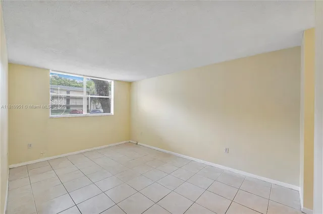 a kitchen with a sink a stove a refrigerator and white cabinets