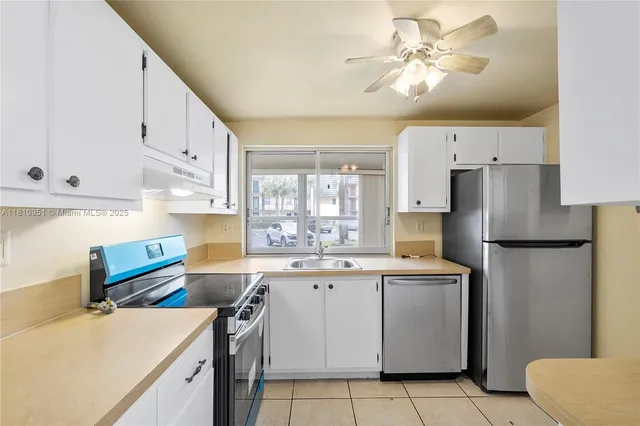 a kitchen with cabinets appliances and a sink