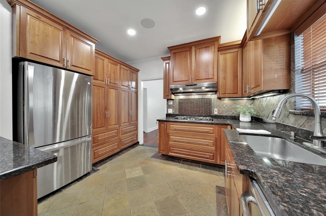 12922 Lentando Drive Cypress, TX 77429 - Photo 11 of 41 a kitchen with stainless steel appliances granite countertop a refrigerator a sink and a stove