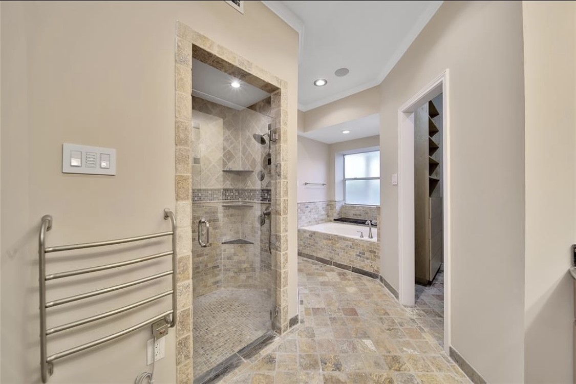 12922 Lentando Drive Cypress, TX 77429 - Photo 19 of 41 a bathroom with a glass shower door and a bathtub