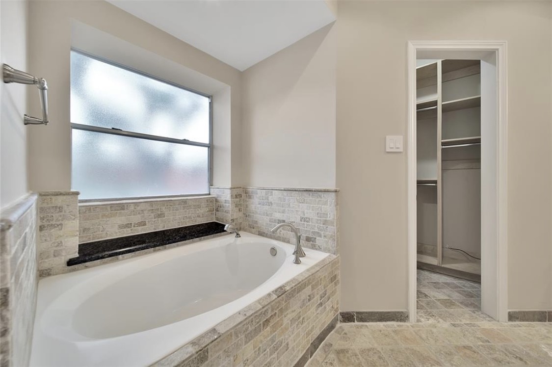 12922 Lentando Drive Cypress, TX 77429 - Photo 21 of 41 a bathroom with a tub and a shower