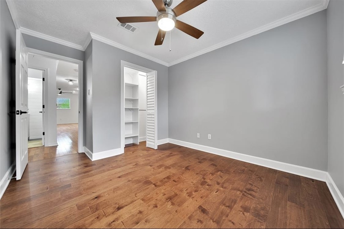 12922 Lentando Drive Cypress, TX 77429 - Photo 25 of 41 an empty room with wooden floor and windows