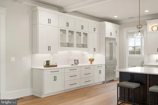 a kitchen with stainless steel appliances kitchen island granite countertop a sink and cabinets