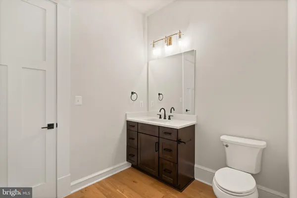 a bathroom with a toilet a sink and mirror