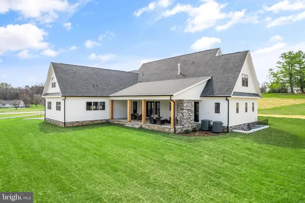 a view of a house with a yard and sitting area