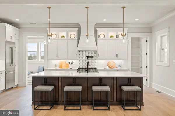 a kitchen with granite countertop a table and chairs in it