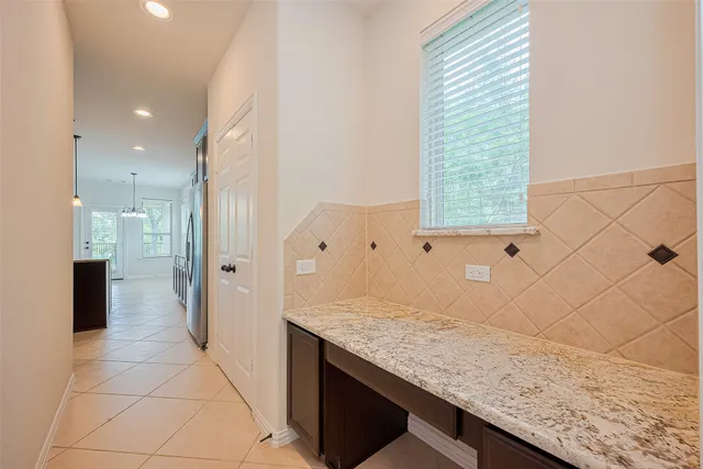a bathroom with a granite countertop sink and shower