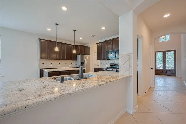 a kitchen with stainless steel appliances a refrigerator sink and cabinets