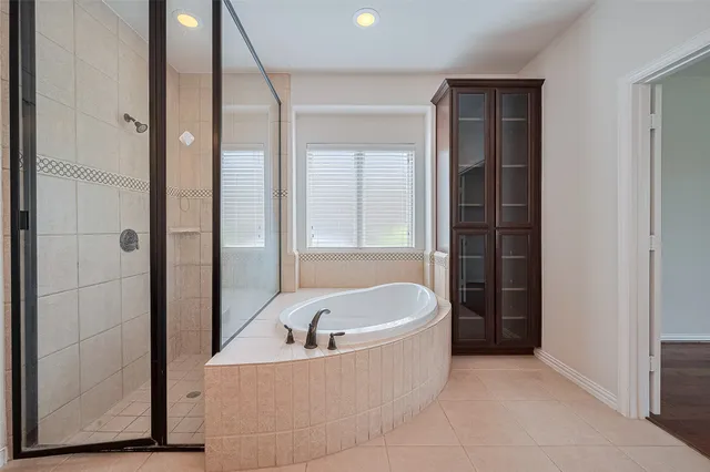 a bathroom with a bathtub and shower