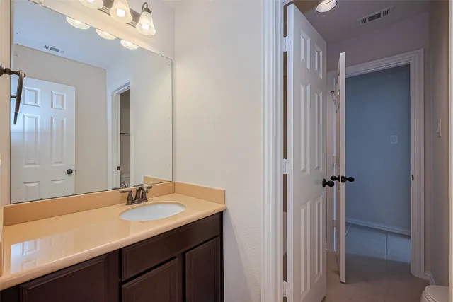 a bathroom with a sink double vanity and a mirror