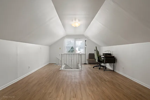 a view of a livingroom with wooden floor and furniture