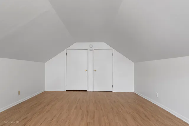 an empty room with wooden floor