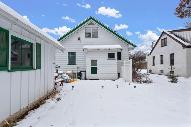 a view of a backyard with a small cabin and a chair