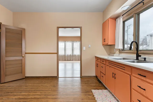 a kitchen with stainless steel appliances granite countertop a sink and a refrigerator