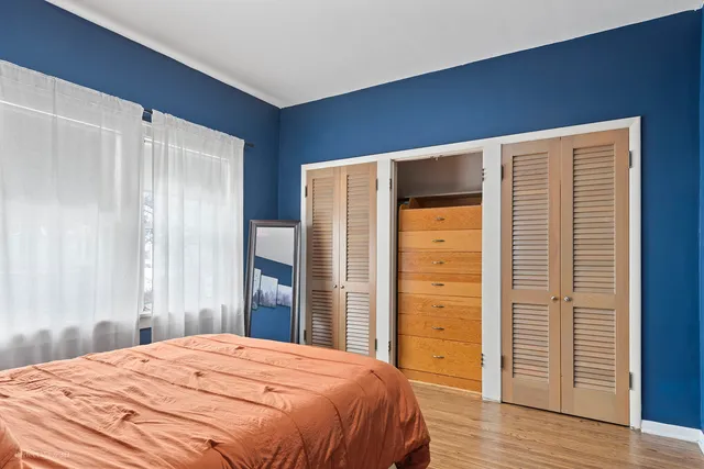 a bedroom with a bed and a dresser