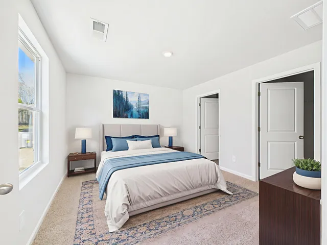 a bedroom with a bed and a potted plant