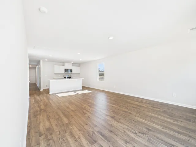 a view of a kitchen with wooden floor and a sink