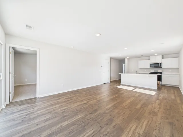 a view of a kitchen with wooden floor and a sink