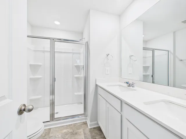 a bathroom with a shower sink and mirror