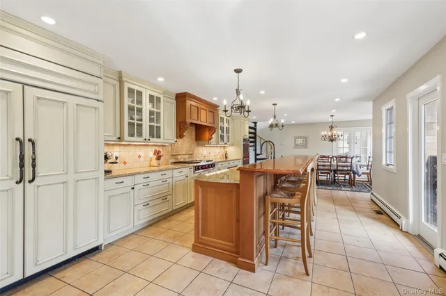 a large kitchen with stainless steel appliances granite countertop a lot of counter space