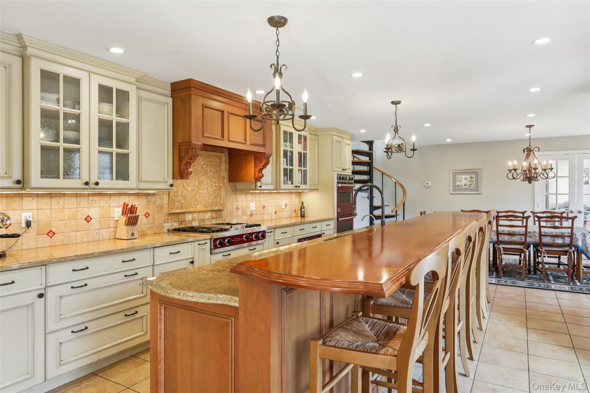 27 Cat Ridge Road North Salem, NY 10560 - Photo 17 of 45 a kitchen with stainless steel appliances granite countertop a stove top oven a sink a dining table and chairs with wooden floor